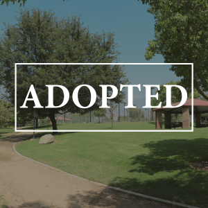 Adopted in white text over a photo of Yucaipa Community Park